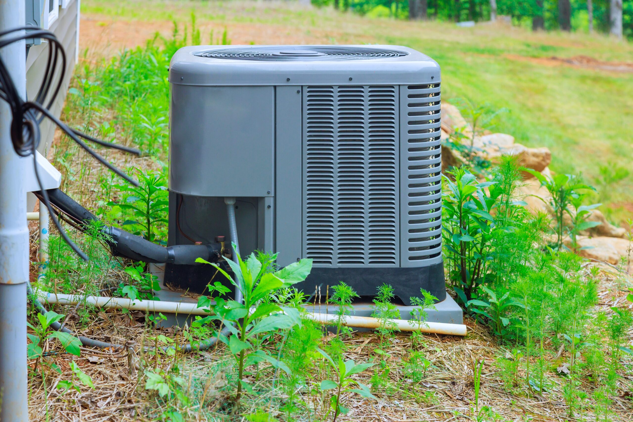 HVAC technician diagnosing Plant City AC humidity problems in a home where the air conditioner is running but indoor humidity remains high.